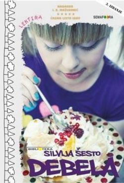 At a birthday party a girl eating a big piece of cake with pleasure.